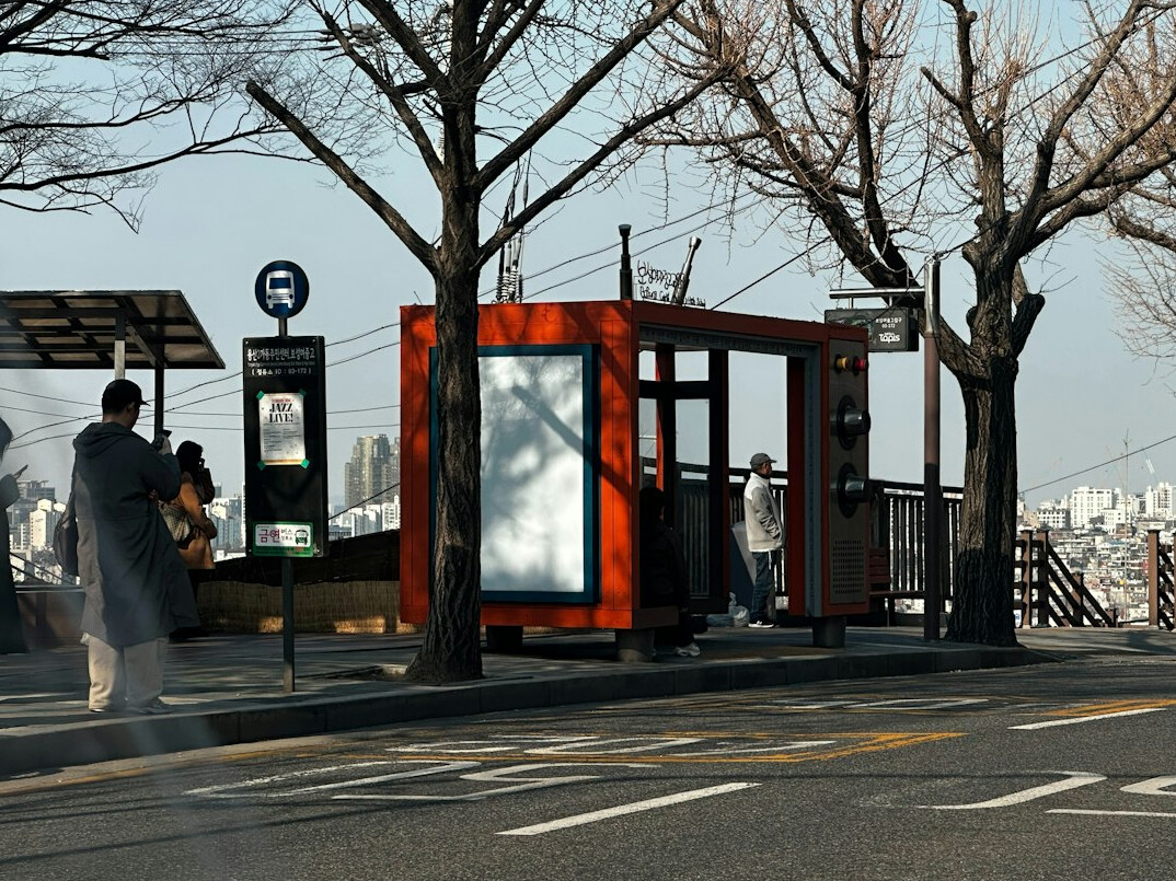 Commuters waiting at an urban bus stop