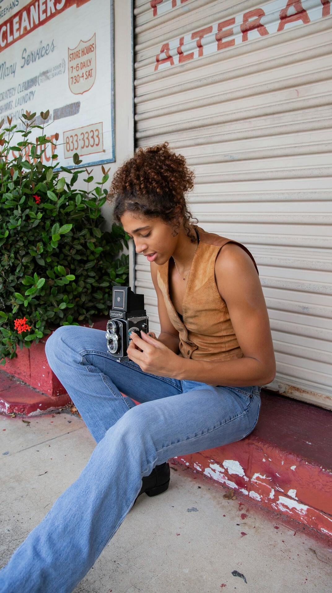 Portrait of a Latina woman photographer holding a camera
